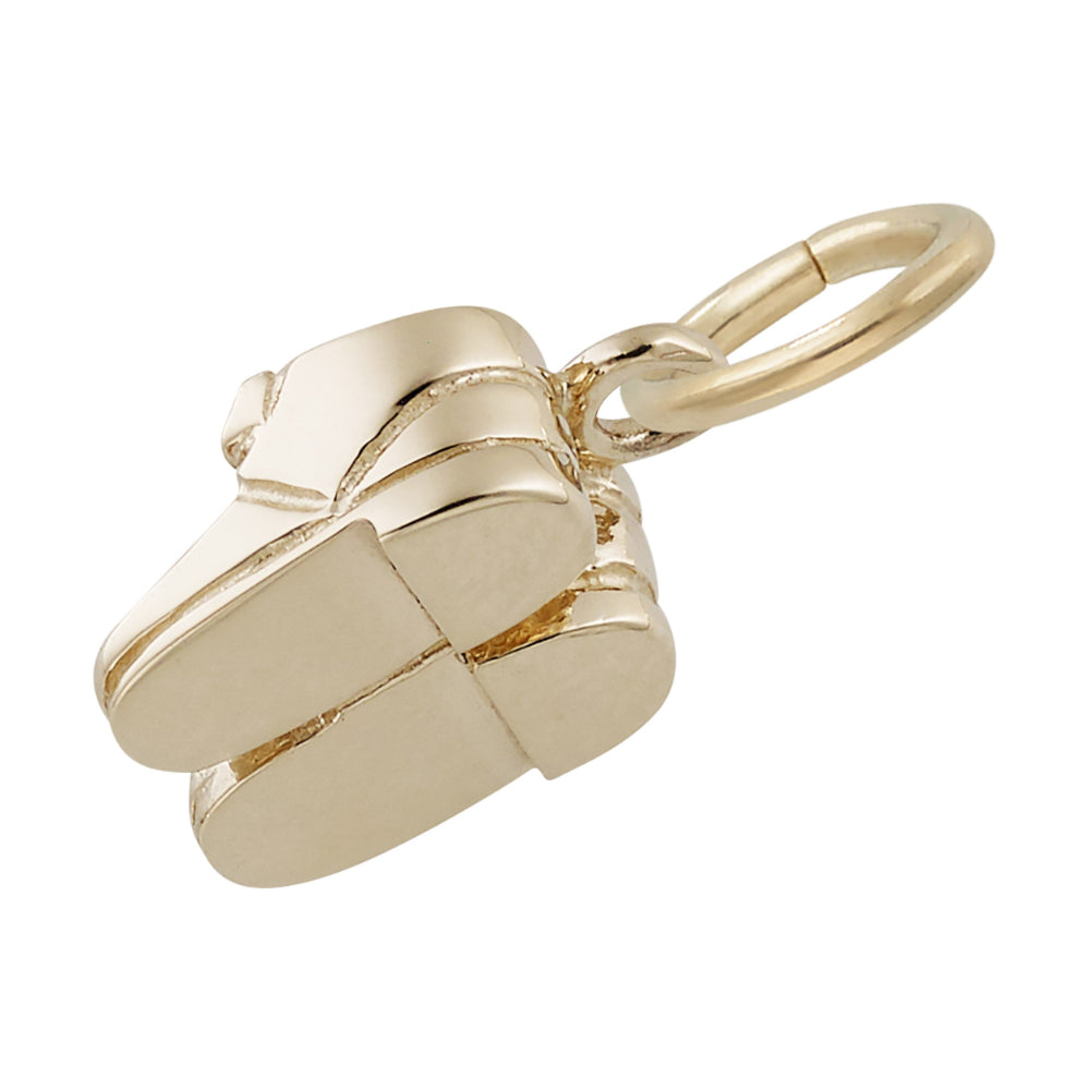 Gold baby shoes charm on a white background bottom view