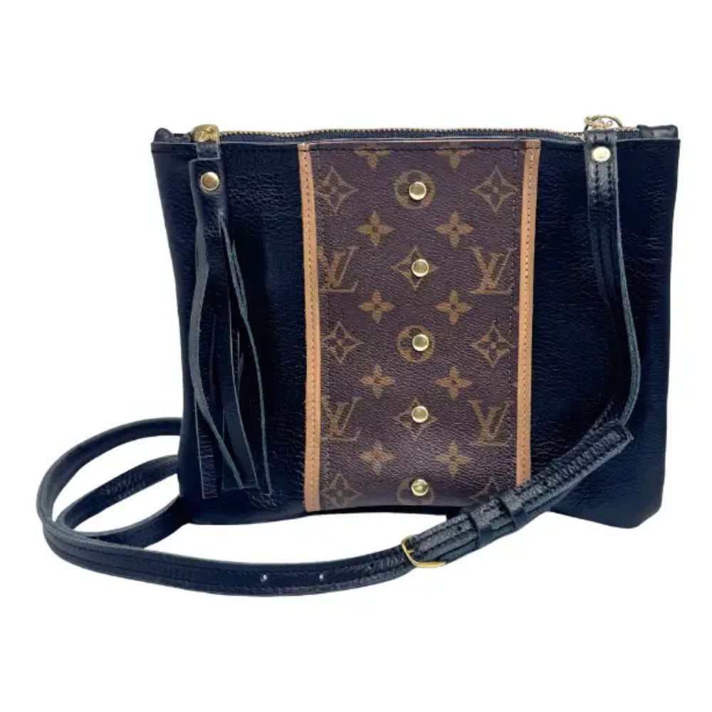 A Louis Vuitton shoulder bag in black leather with a central brown monogram canvas panel and gold-tone hardware, shown on a plain white background.