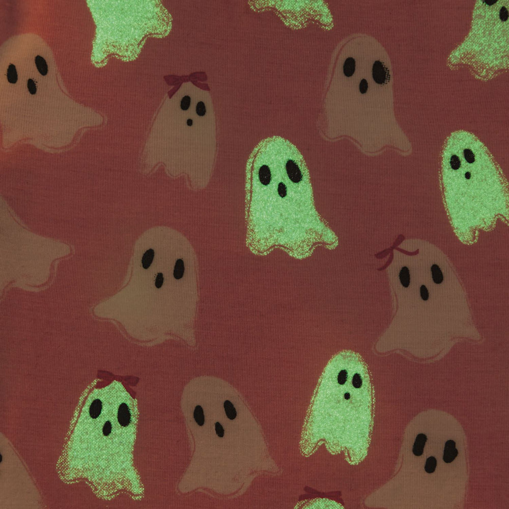 Pattern of glow in the dark ghosts on a dark background