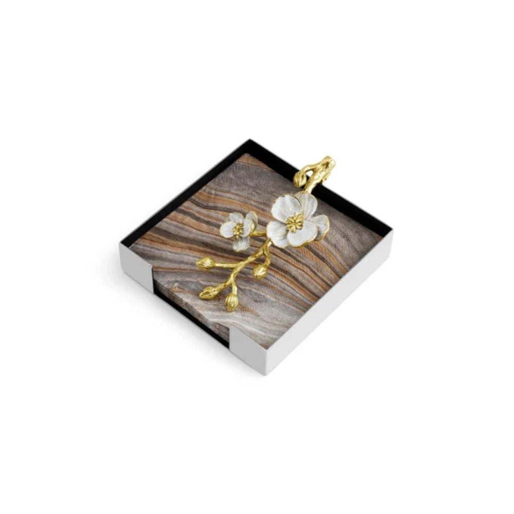 A orchid cocktail napkin holder on a white background.