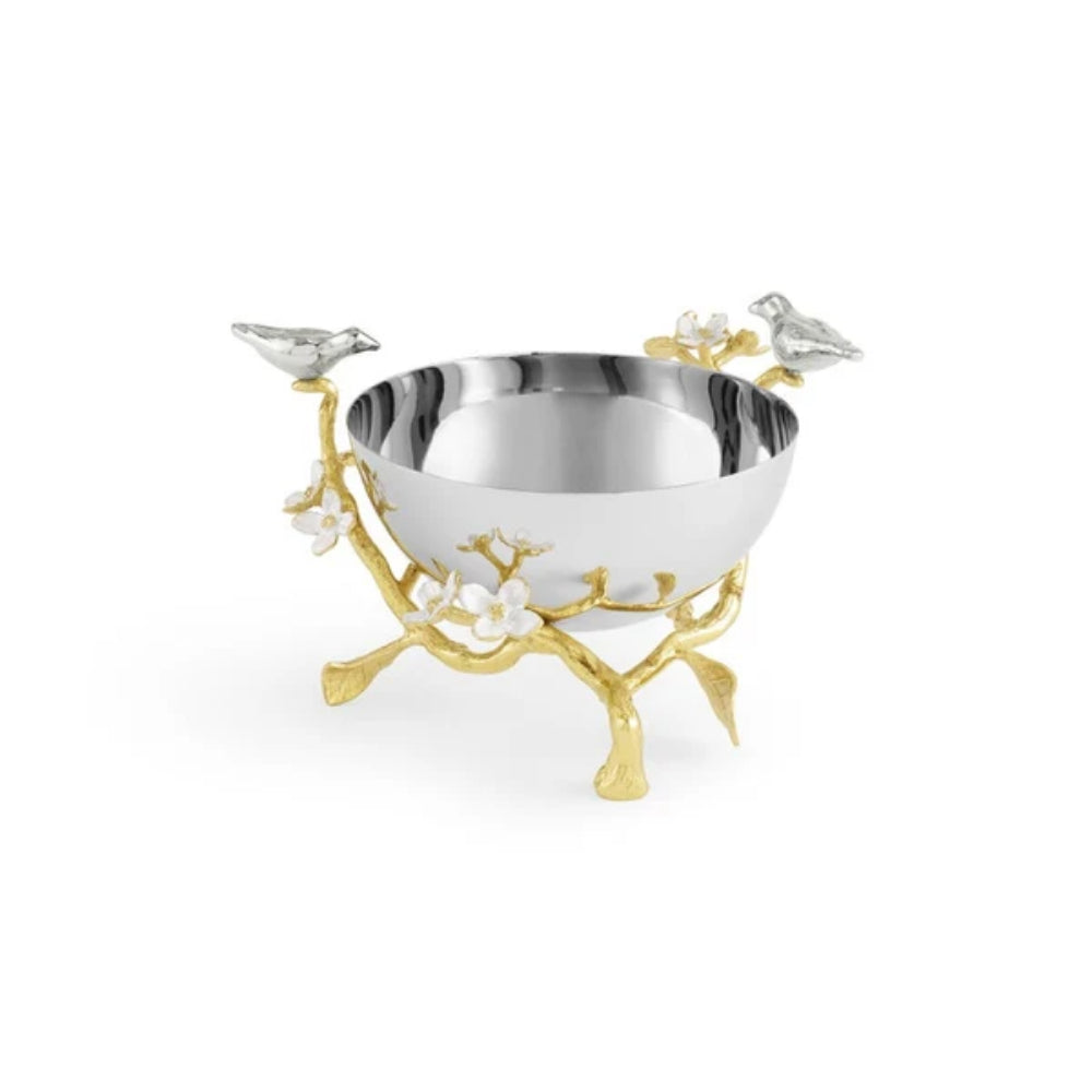 A silver bowl decorated with silver birds and gold arches around the bowl with 2 silver birds on the bowl on a white background.