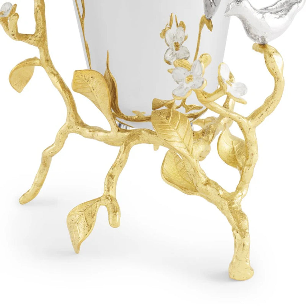 Decorative item with gold branches and white flowers on a white background