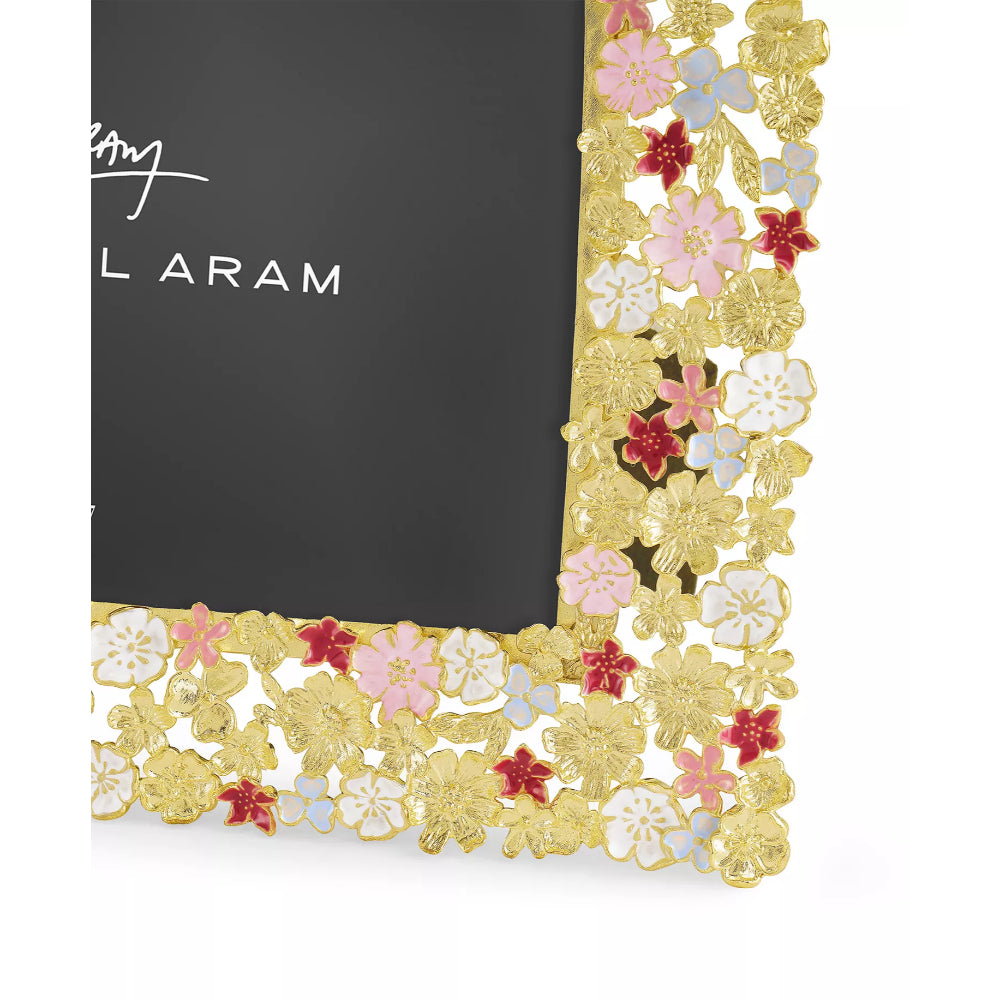 A close up photo of a 5x7 gold frame with colorful floral wildflowers on a white backround