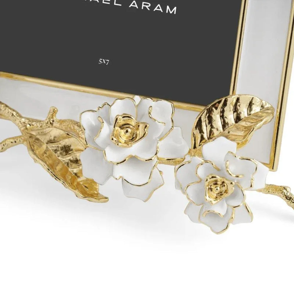 Decorative photo frame with gold floral design on a white background