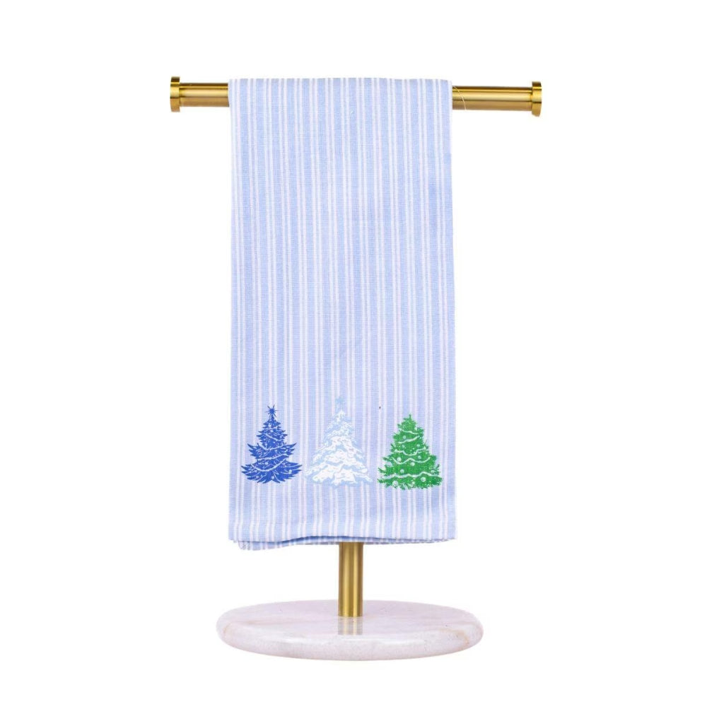A light blue and white vertically striped kitchen towel with embroidered Christmas trees in blue, white, and green, hanging from a gold-colored stand with a round marble base.