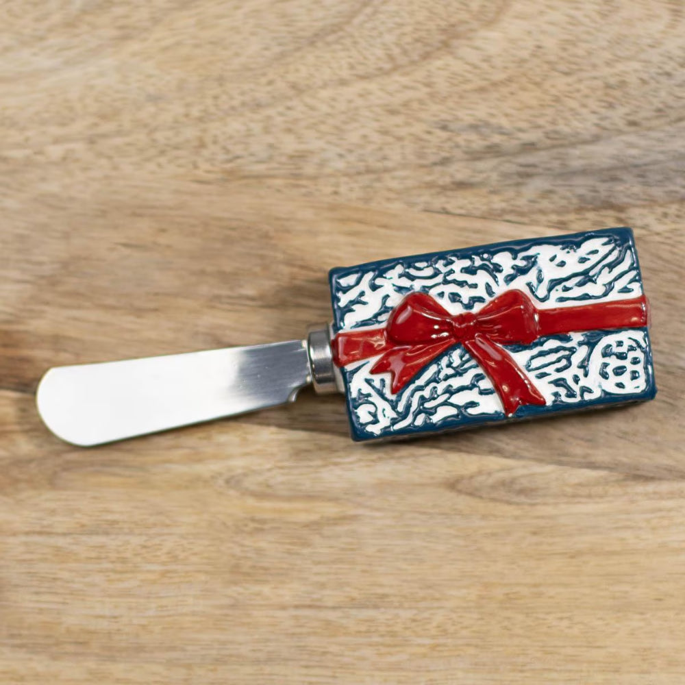 Butter spreader with decorative design on a wooden surface