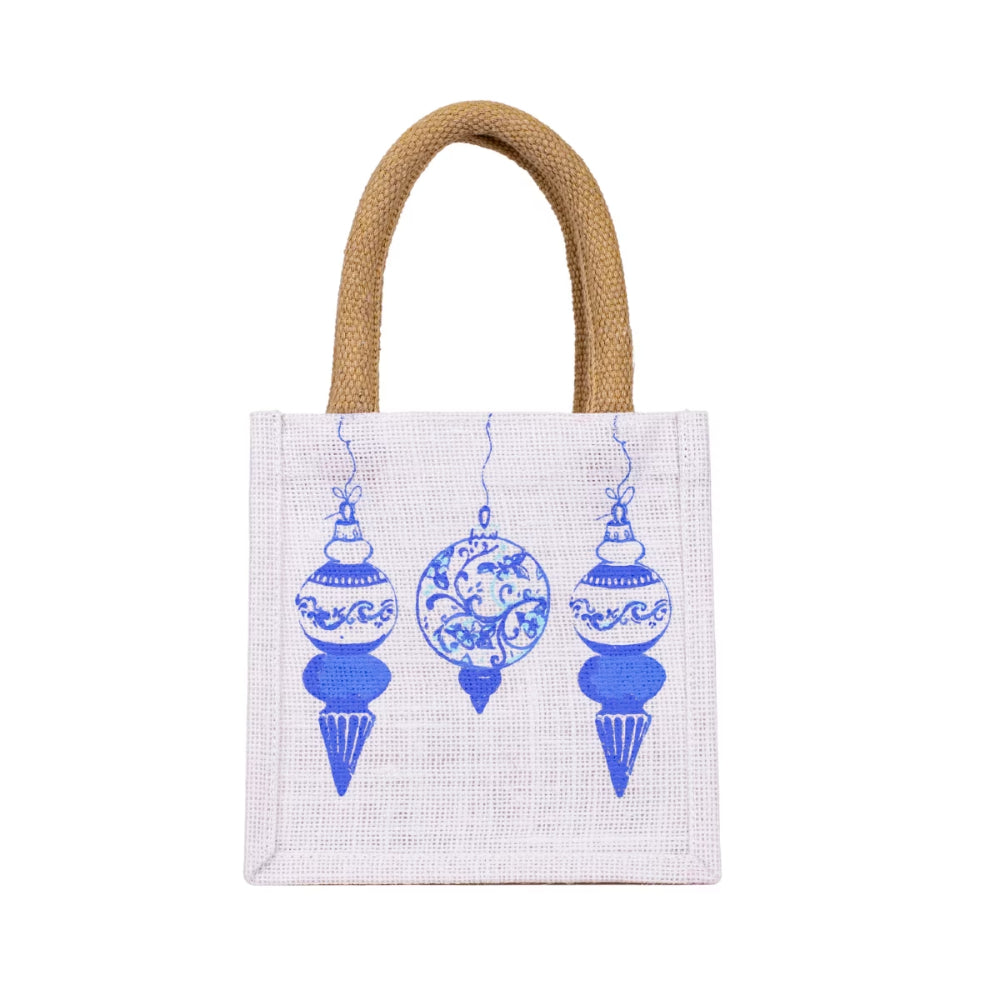 A white canvas tote bag with natural jute handles, decorated with a blue pattern of three hanging ornaments on the front.