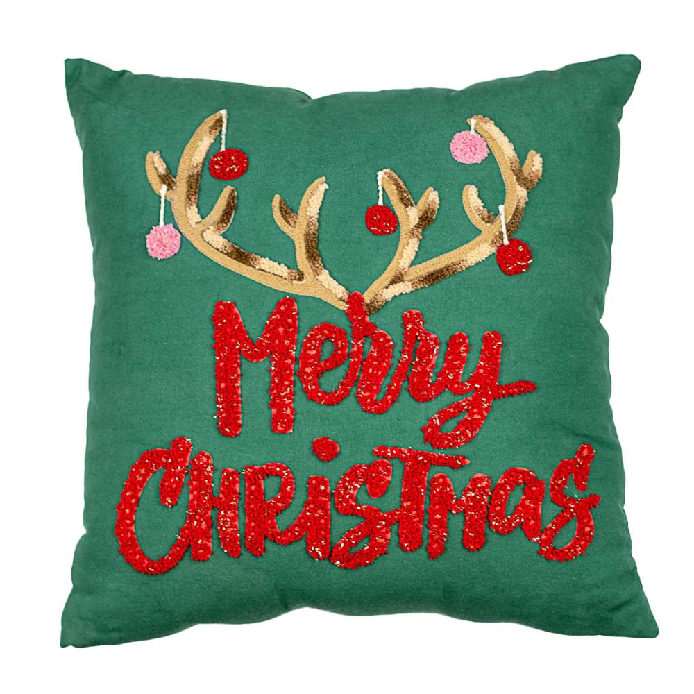 Green pillow with gold antlers and red 'Merry Christmas' text on a white background