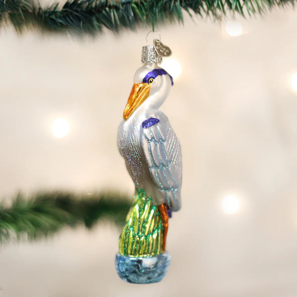 Decorative heron ornament hanging on a Christmas tree.