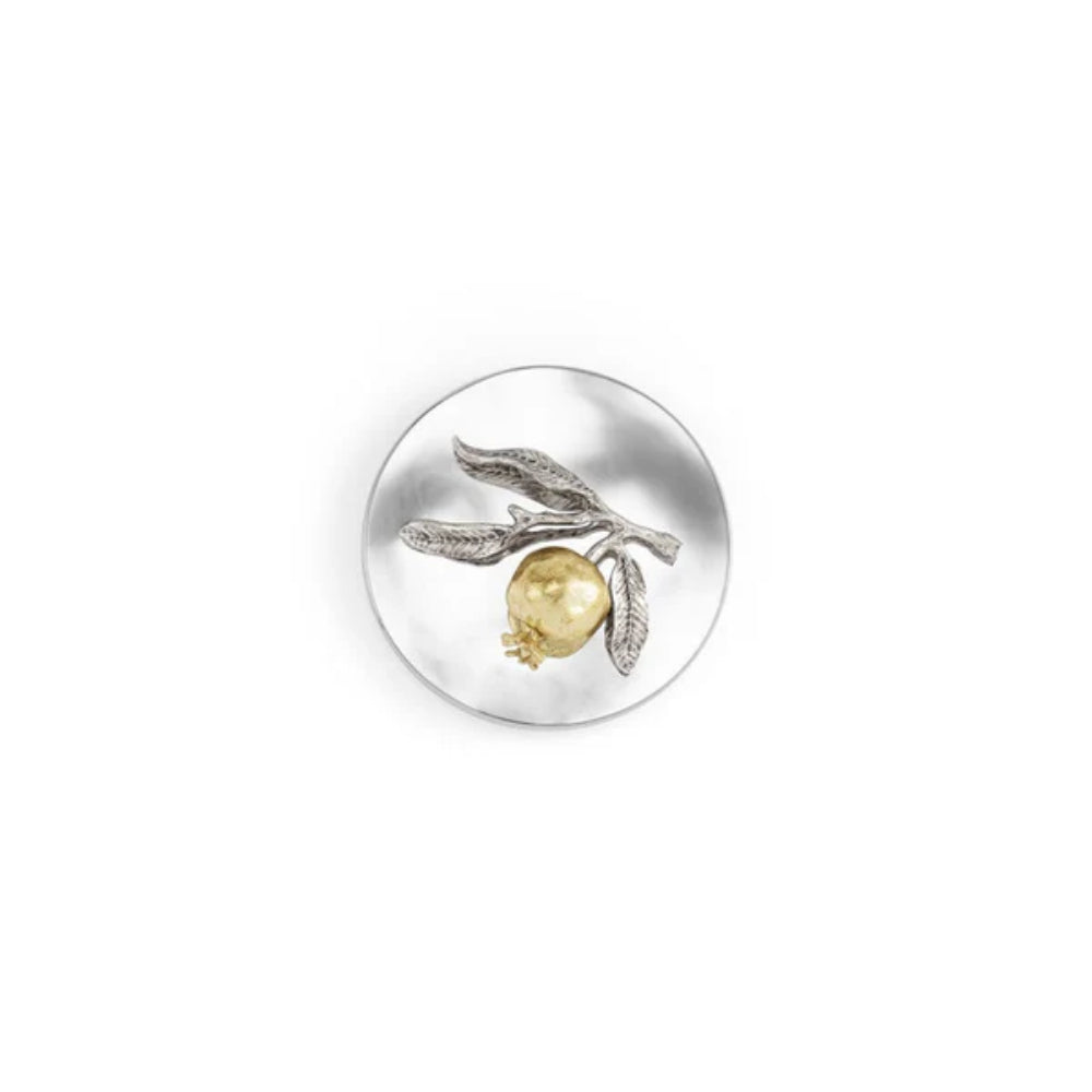 Top of white candle with a silverplated lid with a gold and silver decorative pomegrante on a white backround