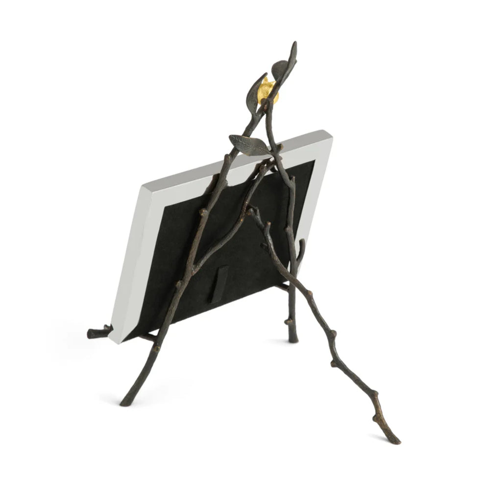 Decorative photo frame with branch design on a white background