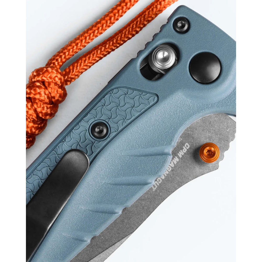 Close-up of a blue folding knife with an orange rope on a white background