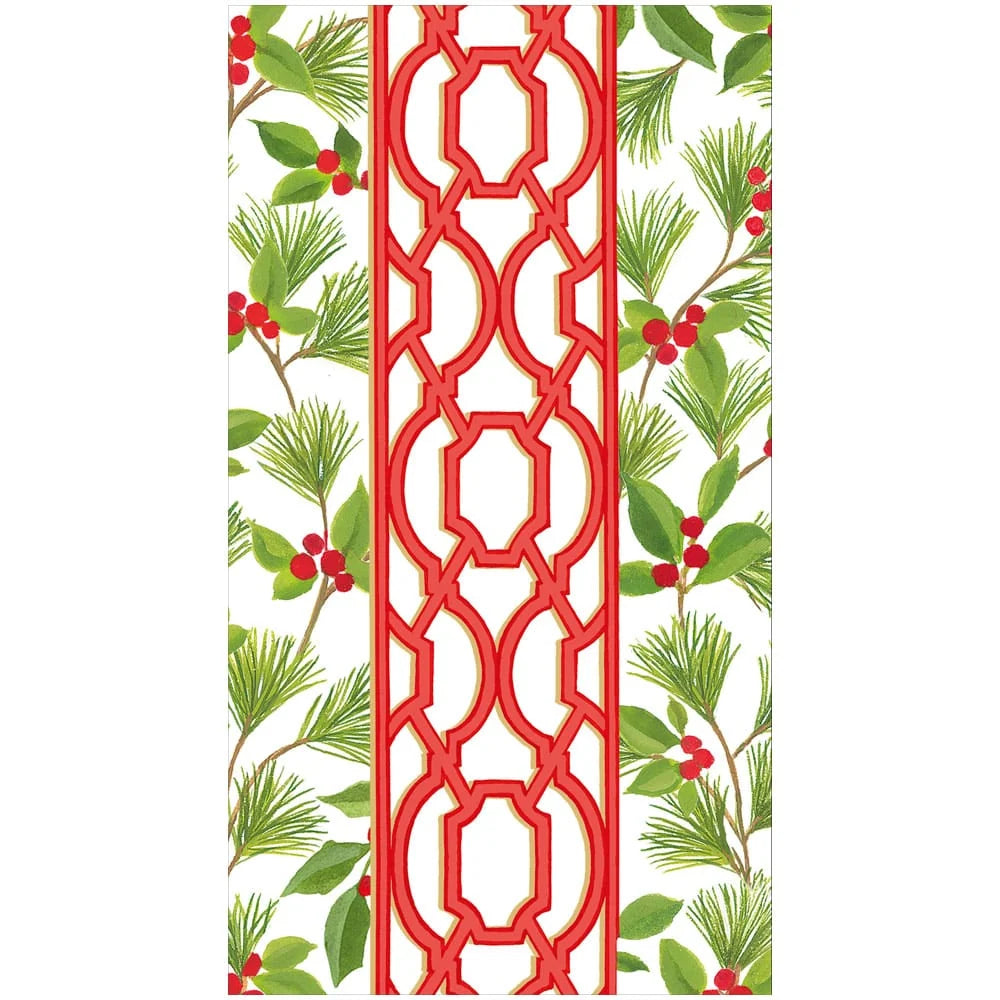 A paper napkin with red geometric trellis pattern in the center, flanked by white side panels with green pine branches and red berries.