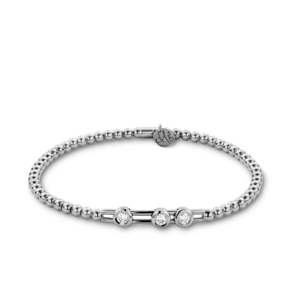 Silver bracelet with three clear gemstones on a white background