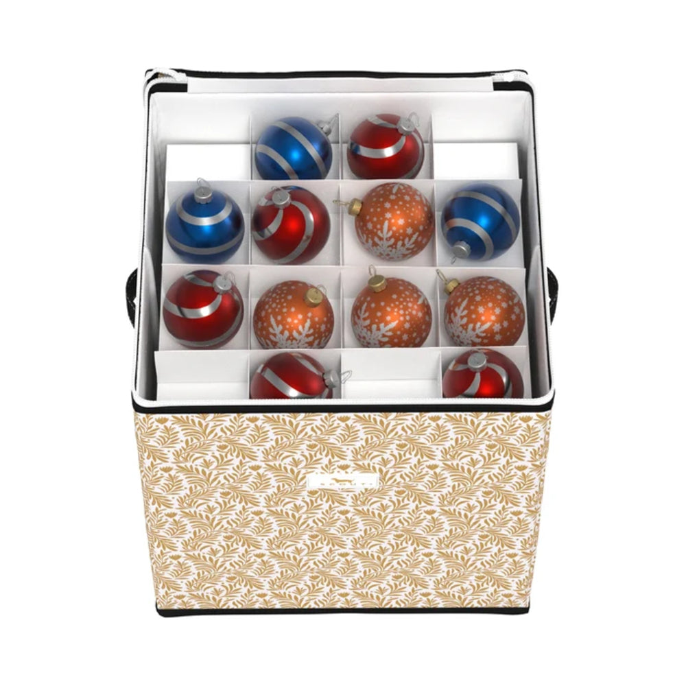 A square storage box with a beige and white leaf pattern exterior, shown open to reveal a white interior organizer divided into compartments holding red and blue Christmas ornaments.
