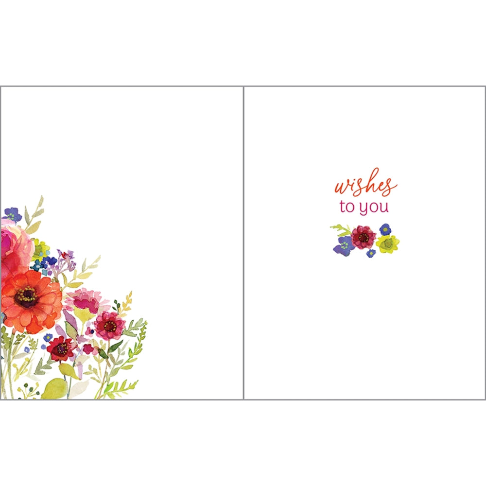 A greeting card shown open, with a white background. The left panel features a colorful watercolor floral arrangement in the lower left corner, and the right panel has the words 'wishes to you' in coral and pink lettering above a small matching floral cluster.