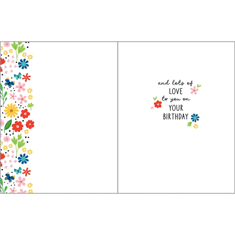 An open greeting card with a white background. The left panel features a vertical border of colorful flowers in red, yellow, blue, pink, and green.