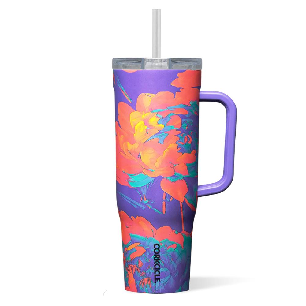 Purple tumbler with a orange floral design with handle, straw and clear lid on a white background.