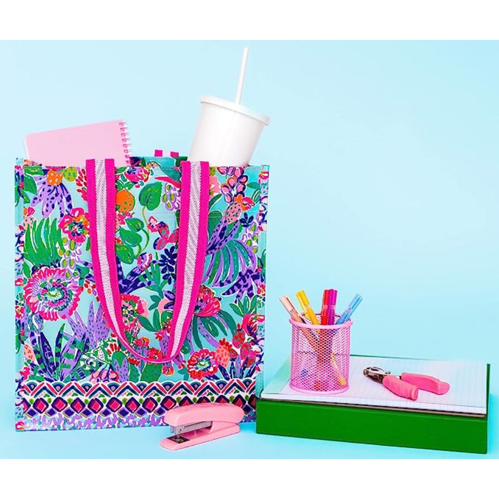 Colorful tote bag with stationery items on a blue background.