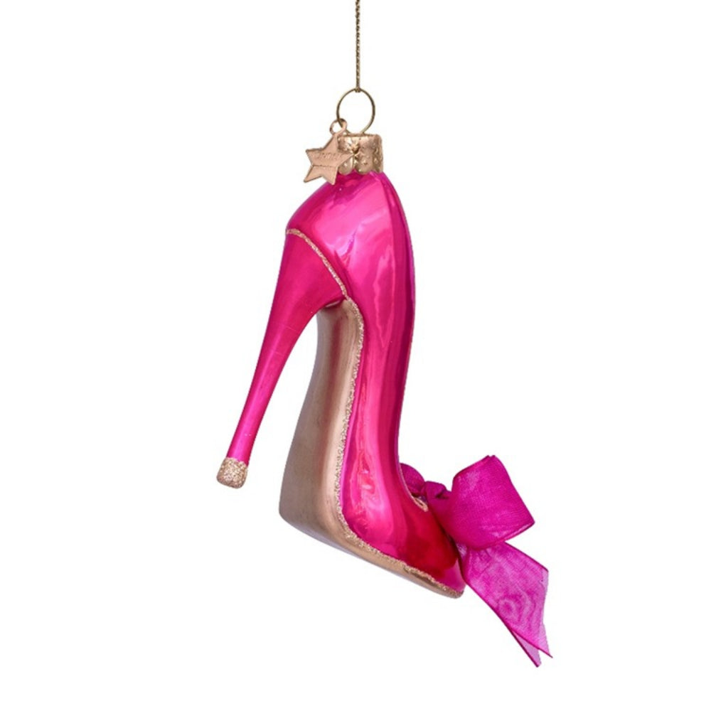 Glass ornament shaped like a high-heeled shoe with pink ribbon on a white background