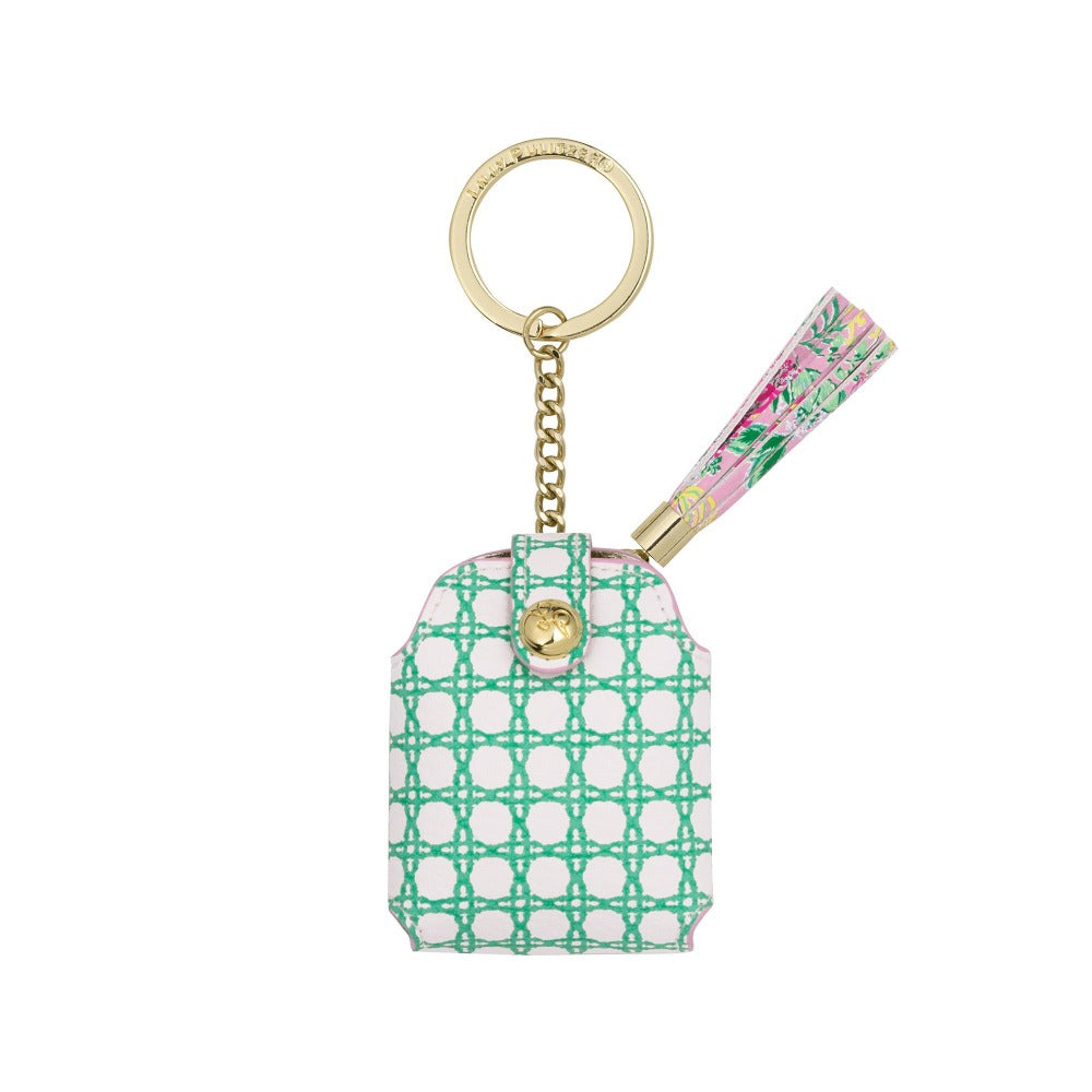 Keychain with a green geometric pattern and floral tube for carring earbuds on a white background