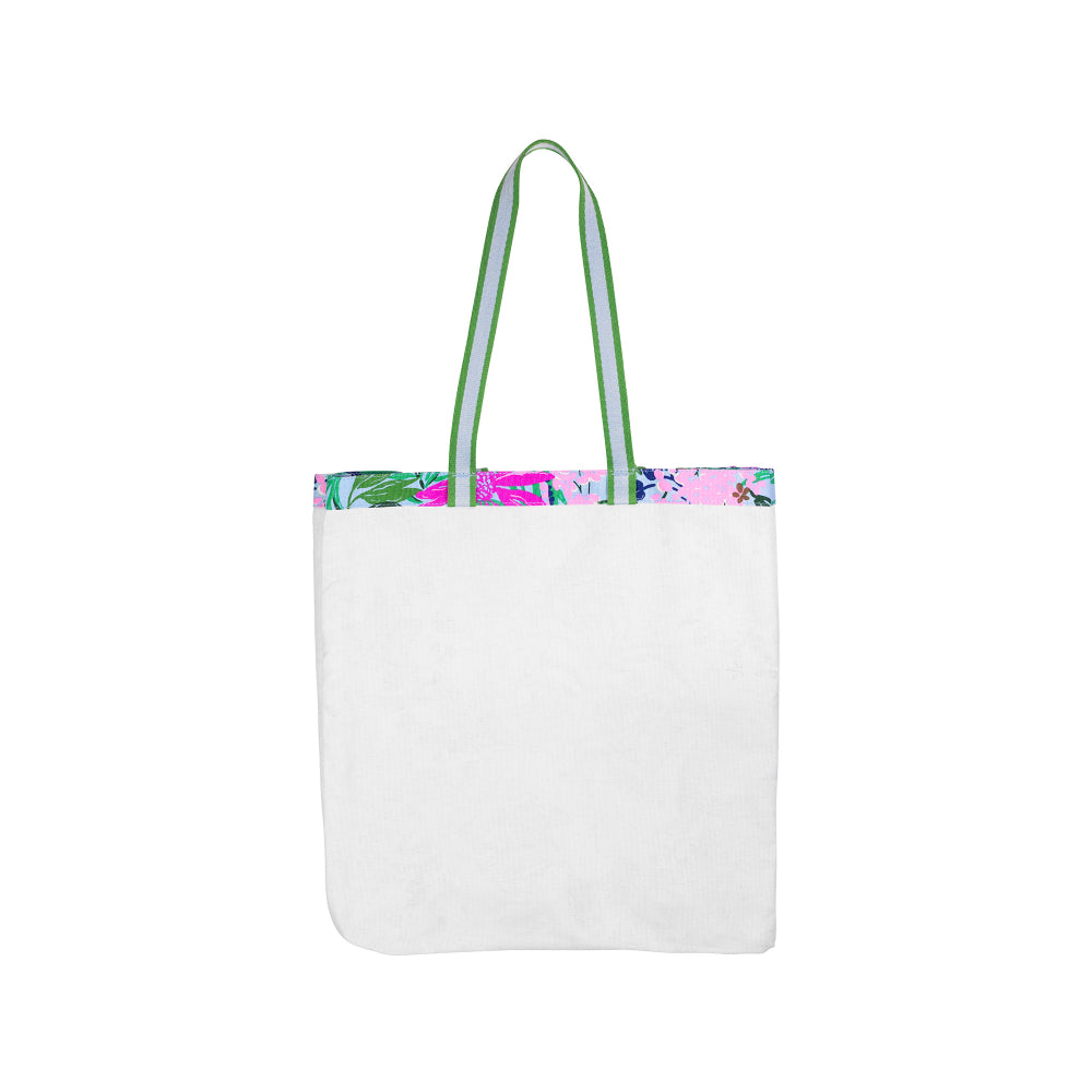 White tote bag with floral patterned trim on a white background