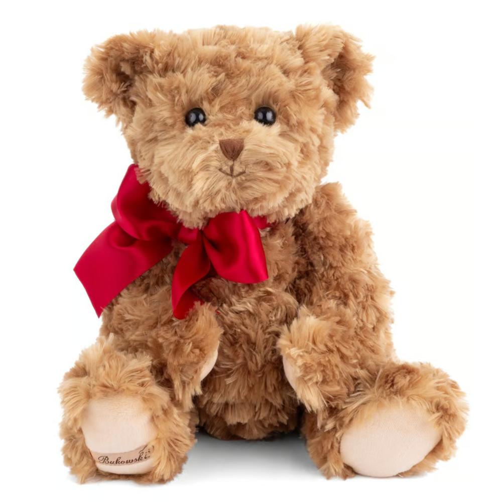 A brown plush teddy bear with a bright red satin bow around its neck, sitting against a solid white background. The bear has black bead eyes, a stitched brown nose, and light beige paws and feet.