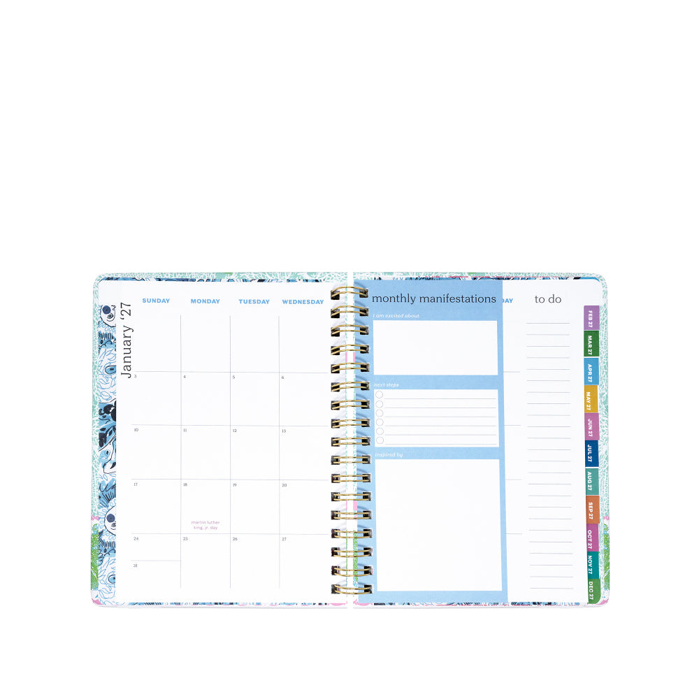 Planner with monthly layout and colorful tabs on a white background