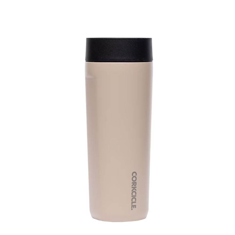 Beige travel mug with black lid on a white background.