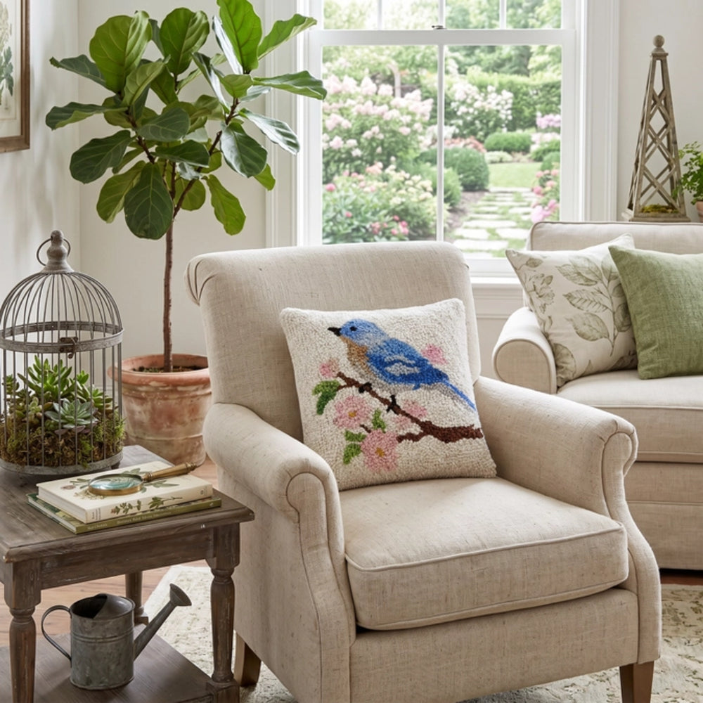 Beige armchair with decorative pillows in a cozy living room setting