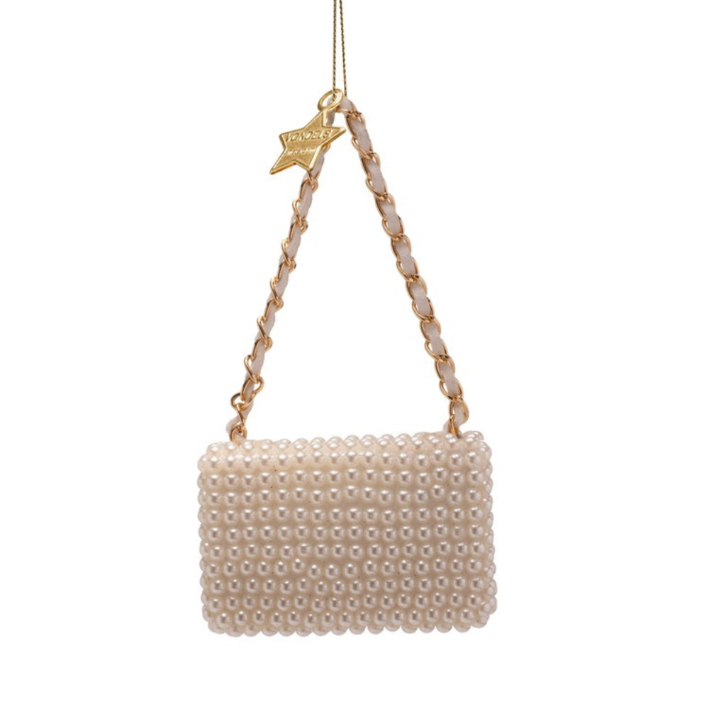 Pearl-handled handbag ornament with gold accents on a white background