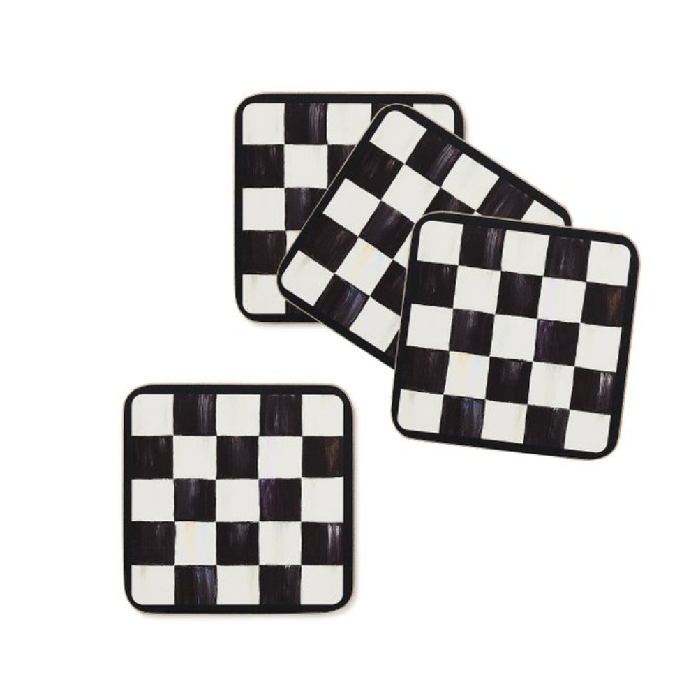 Set of four black and white checkered coasters on a white background