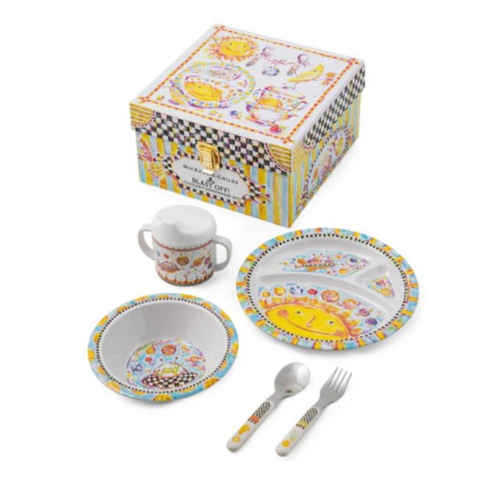 Children's dinnerware set with smiling face design on a white background