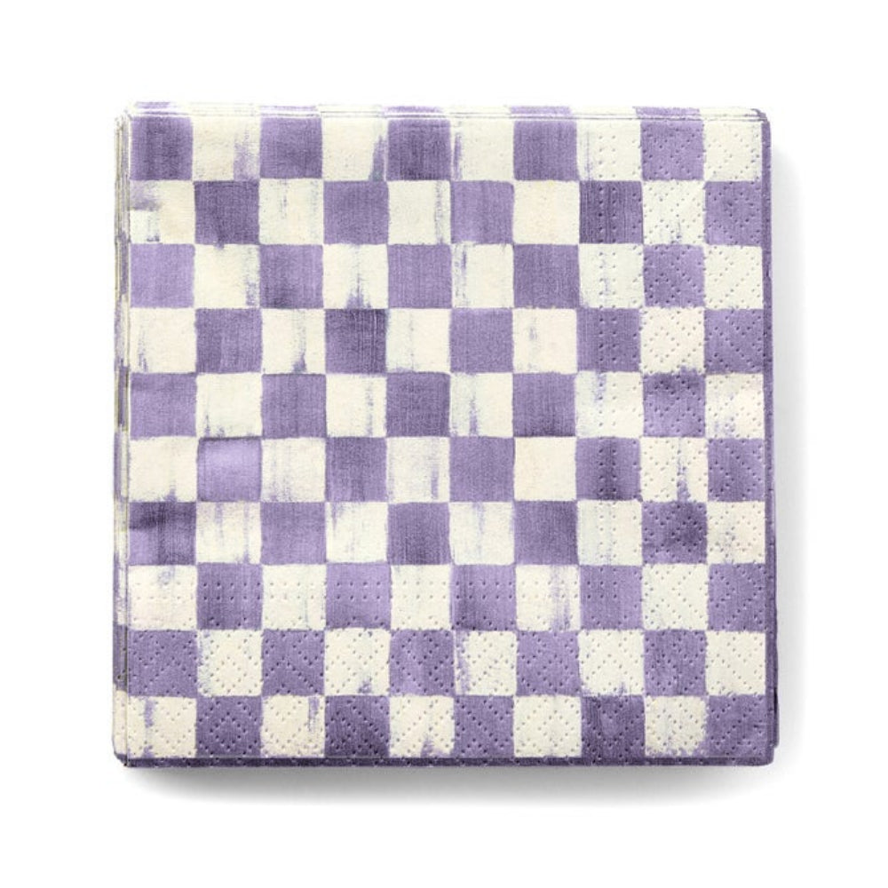 A square paper napkin with a purple and off-white checkerboard pattern, featuring a subtle distressed texture and perforated edges, shown on a plain white background.