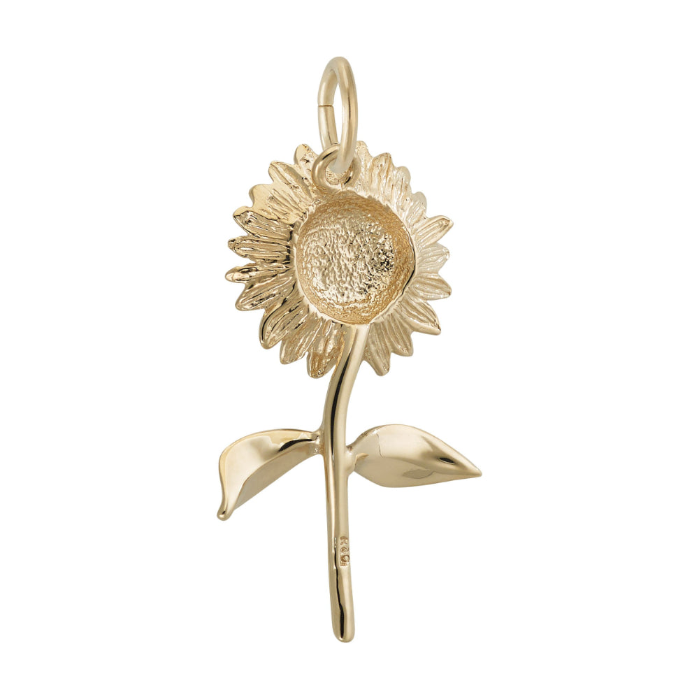 Back of A gold sunflower charm pendant with detailed petals, a textured center, and two leaves on a stem, shown against a plain white background.