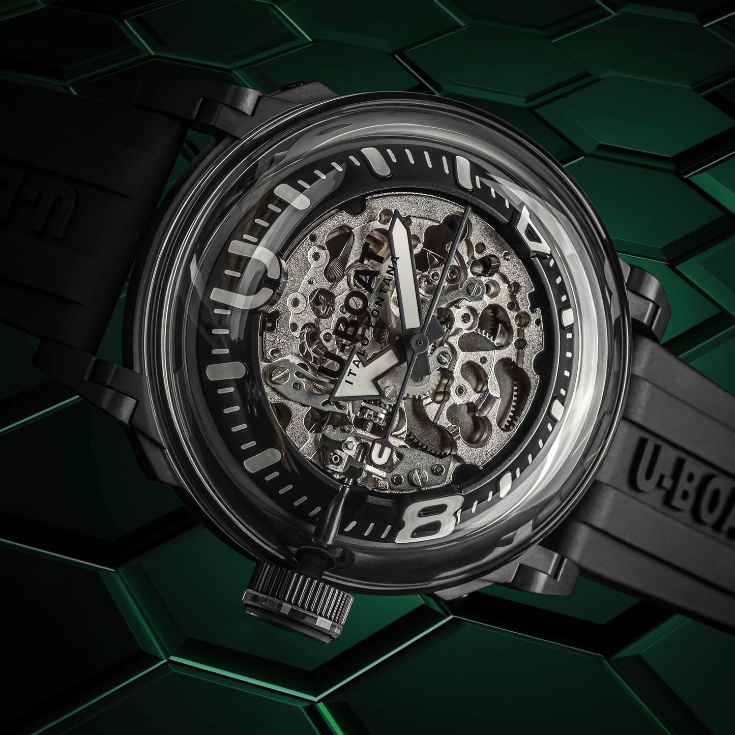 Mechanical watch with transparent case on a green geometric patterned background