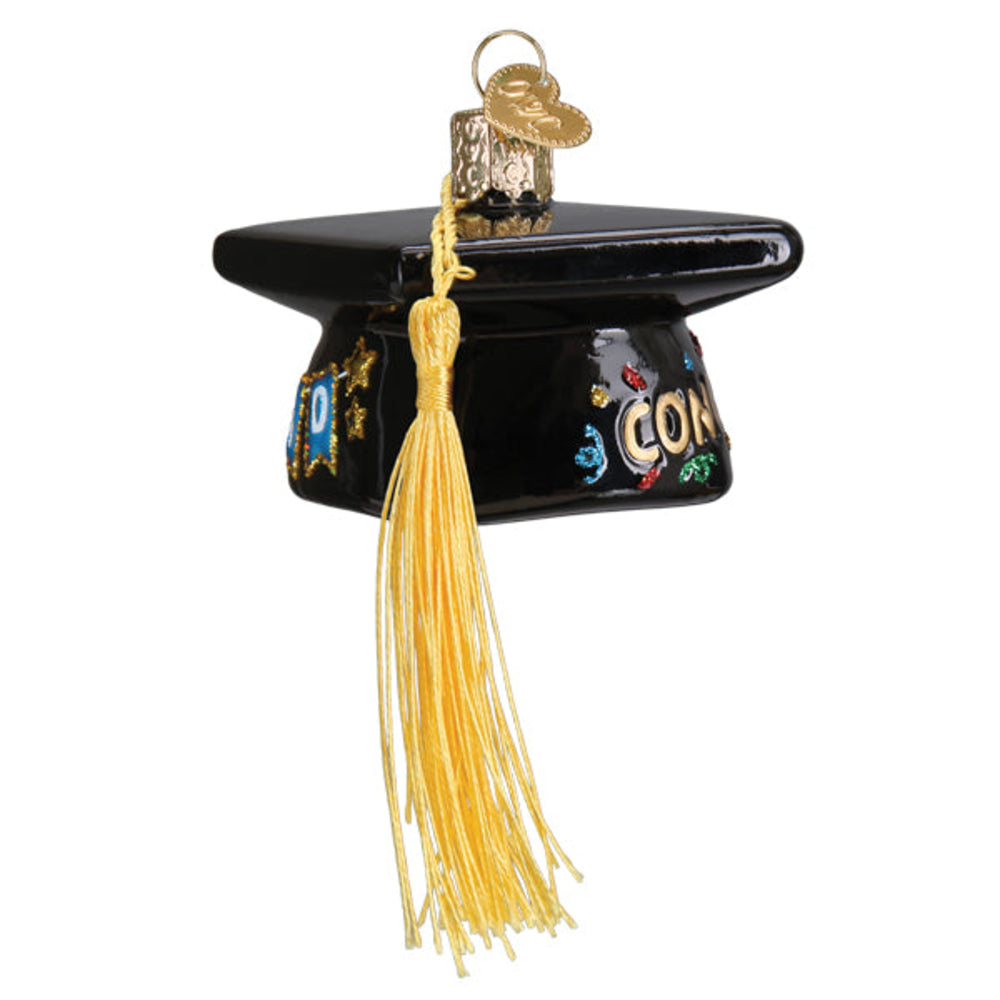 Decorative graduation cap ornament with yellow tassel on a white background