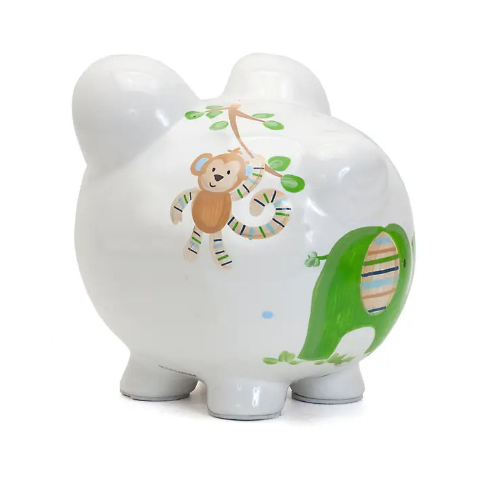 Back side photo of a white piggy bank with colorful designs and a brown monkey on a white background