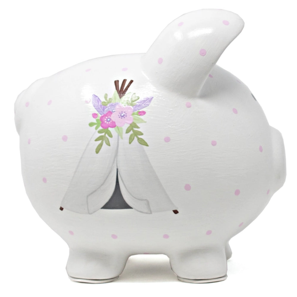A piggy bank with purple polka dots and floral designs on white background.