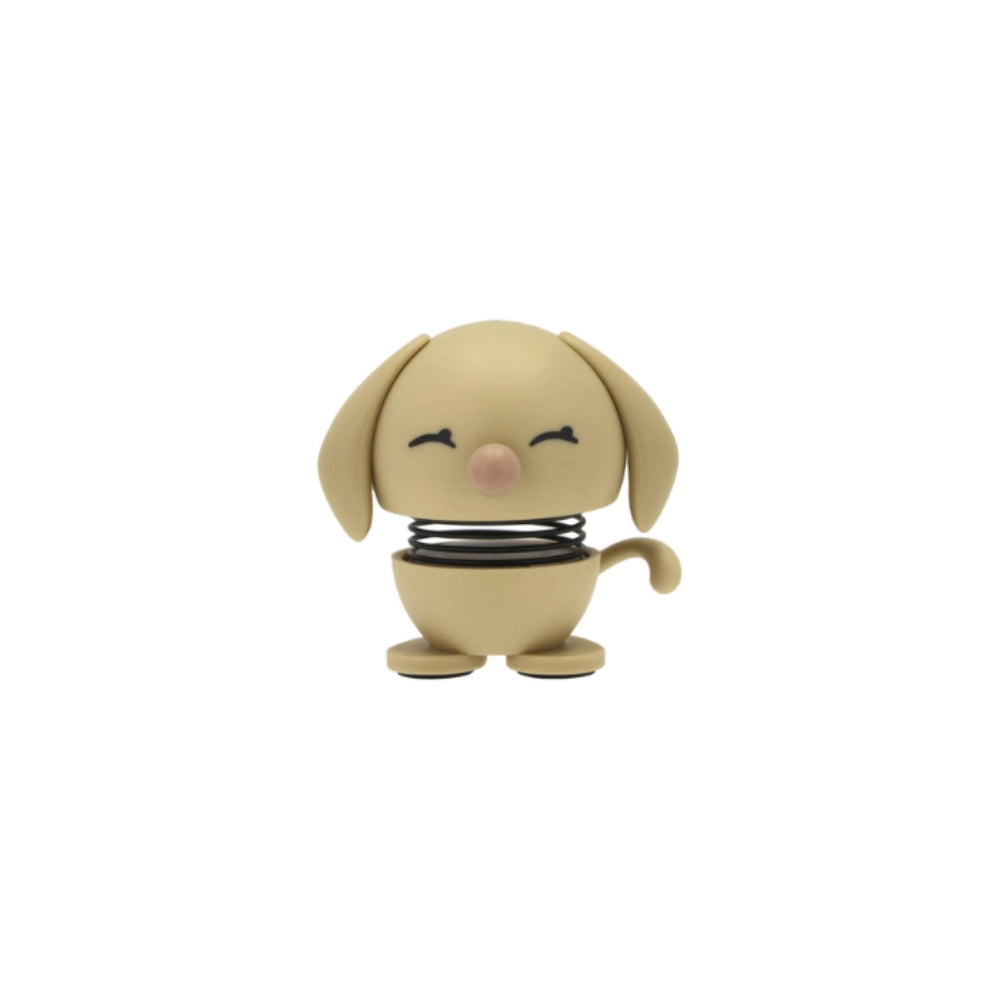 Beige dog-shaped object with a spring figurine on a white background