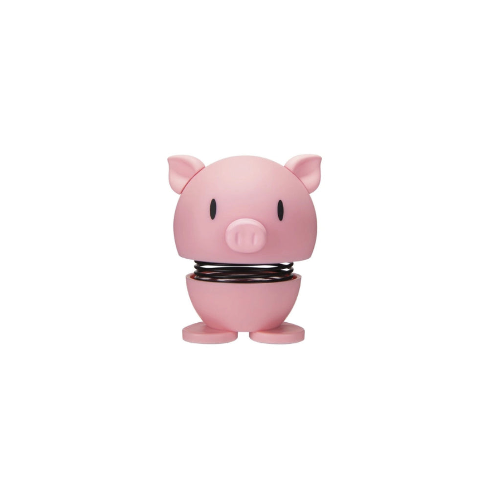 Pink pig shaped figurine with a face and a spring on a white background