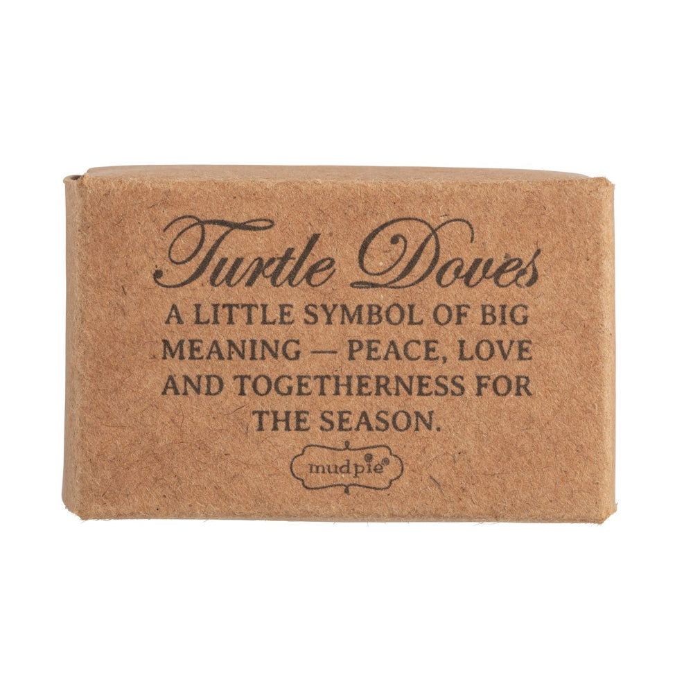 A rectangular kraft paper box with printed text reading 'Turtle Doves' and a quote about peace, love, and togetherness for the season, on a white background.