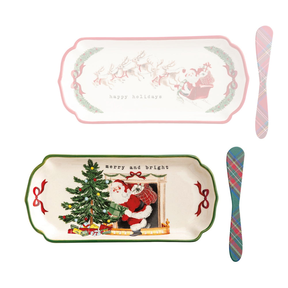 Set of Christmas-themed plates and cutlery with Santa Claus and tree designs on a white background.
