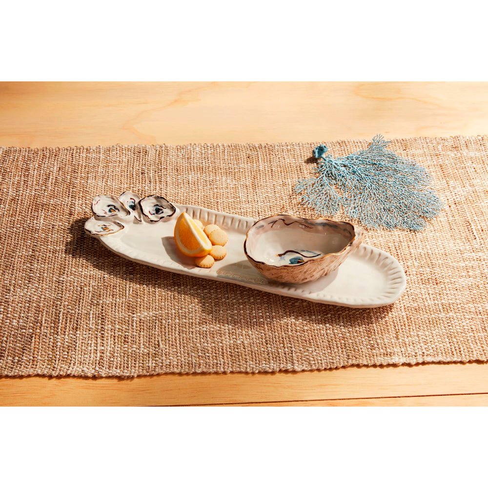 Oyster shell tray on a tan a table setting backround.