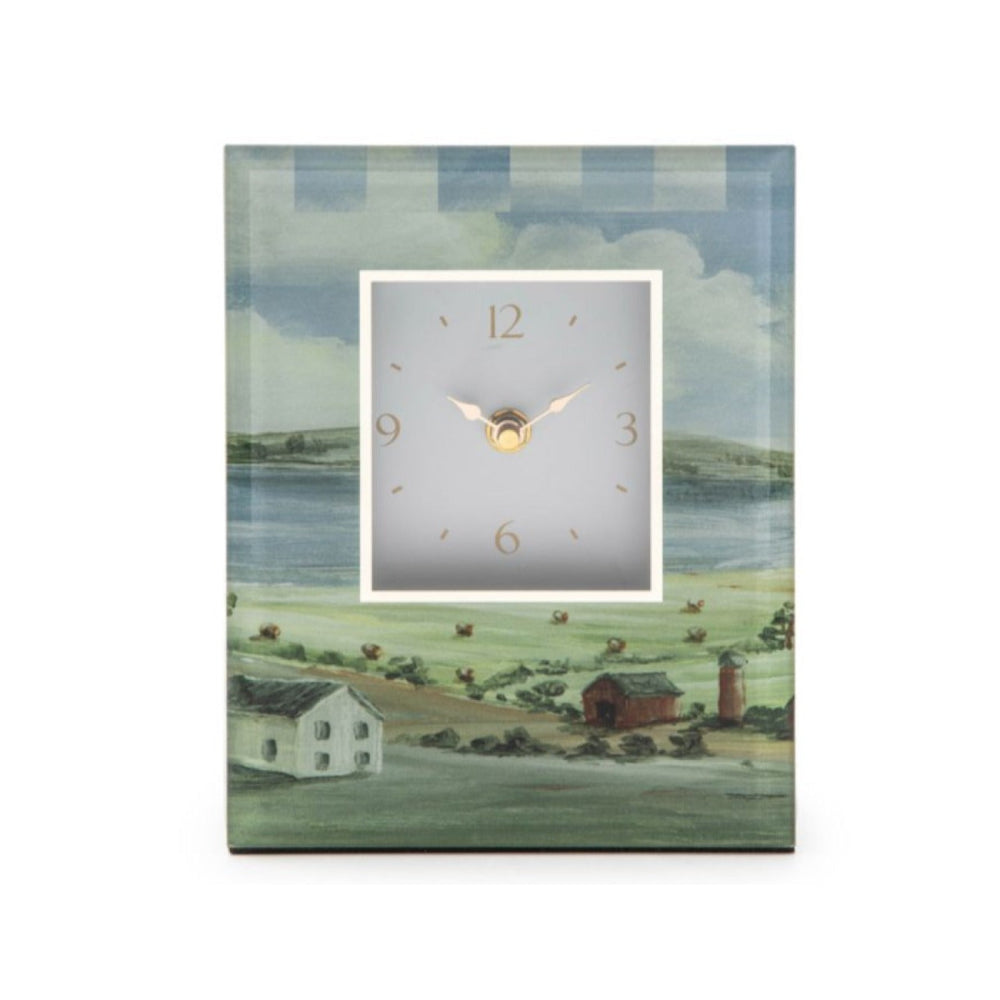 Decorative clock with a landscape design on a white background