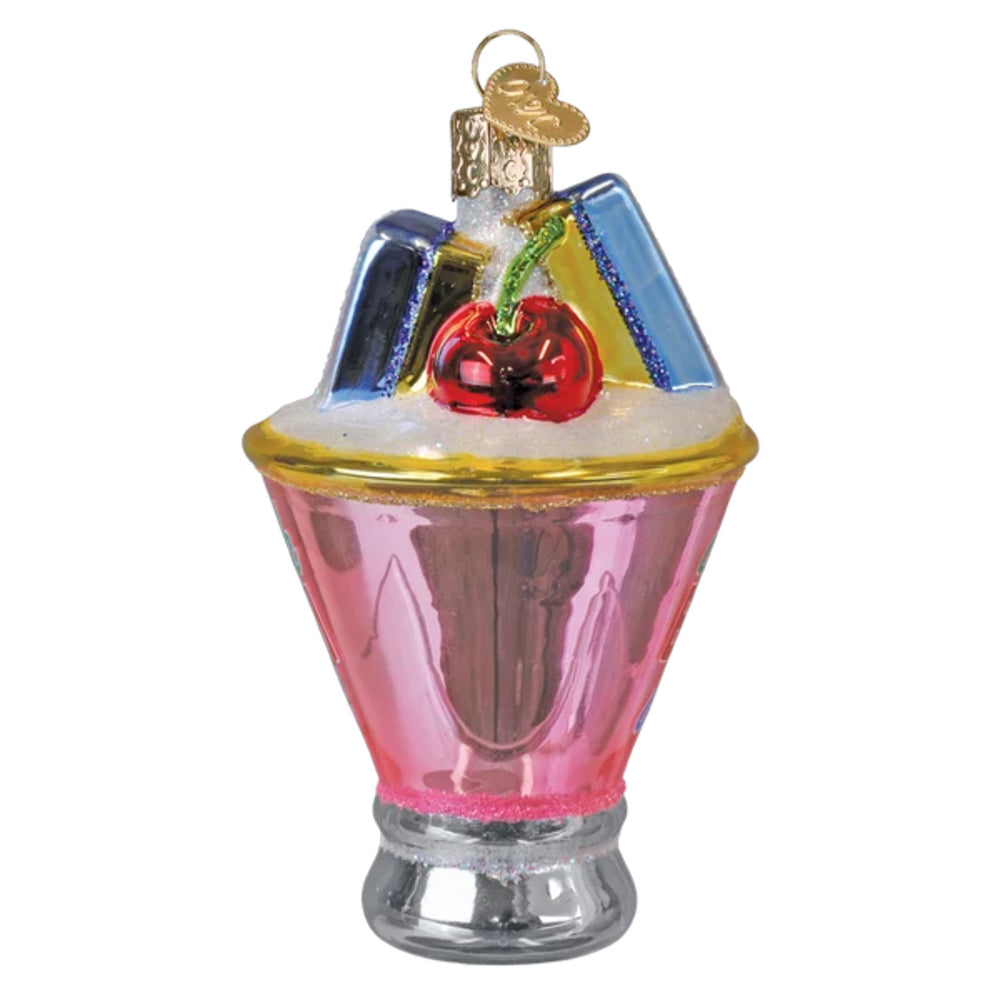 Decorative glass Christmas ornament shaped like a pink cocktail with a cherry on top, on a white background.