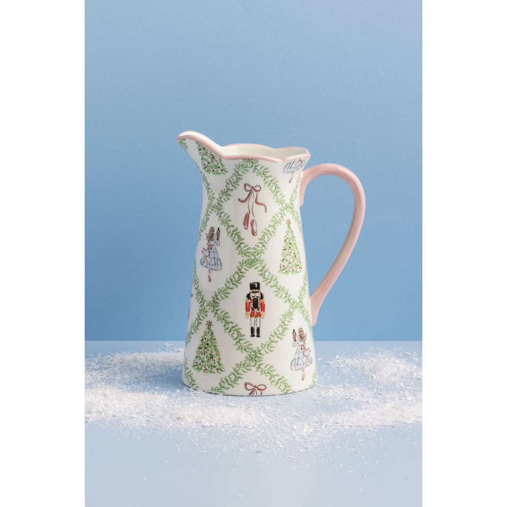 Decorative ceramic pitcher with Christmas-themed design on a blue background