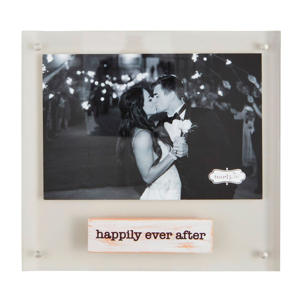 Framed black and white photo of a couple kissing with 'happily ever after' plaque below.