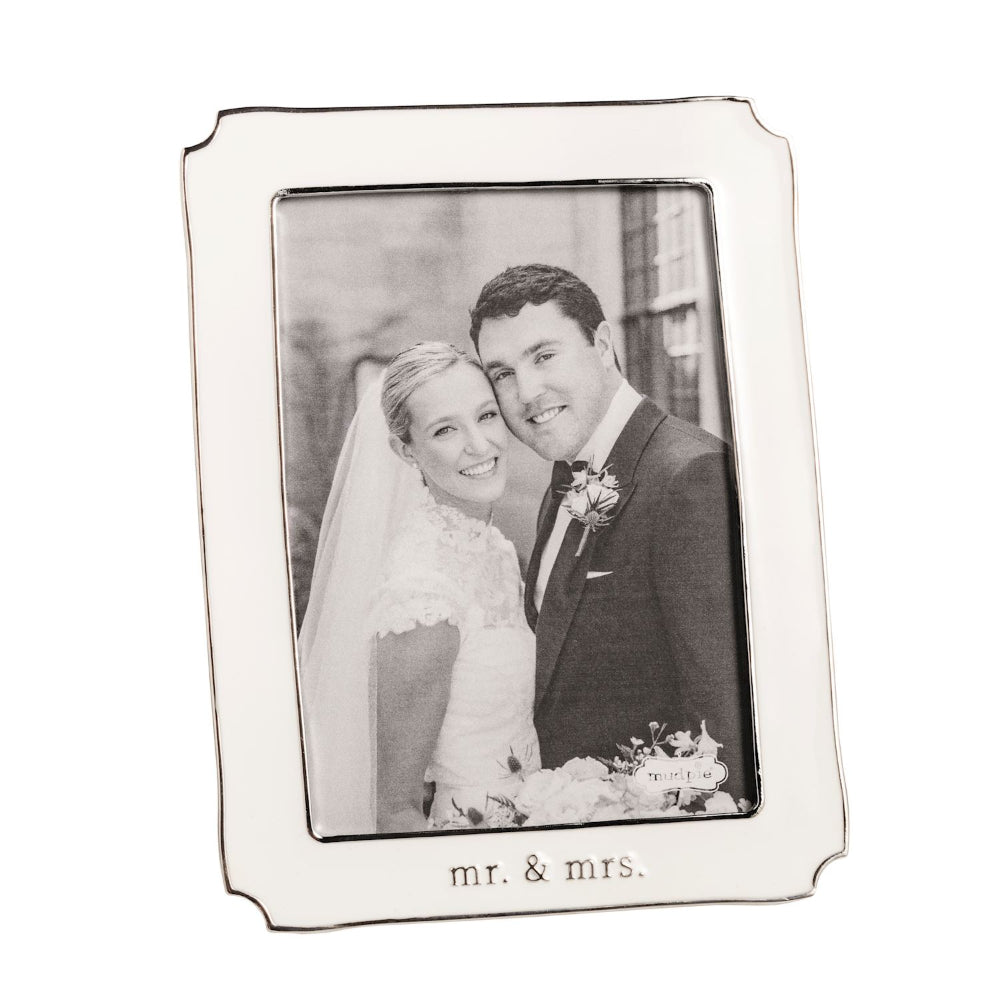 White photo frame with 'mr. & mrs.' text, holding a wedding photo of a couple.