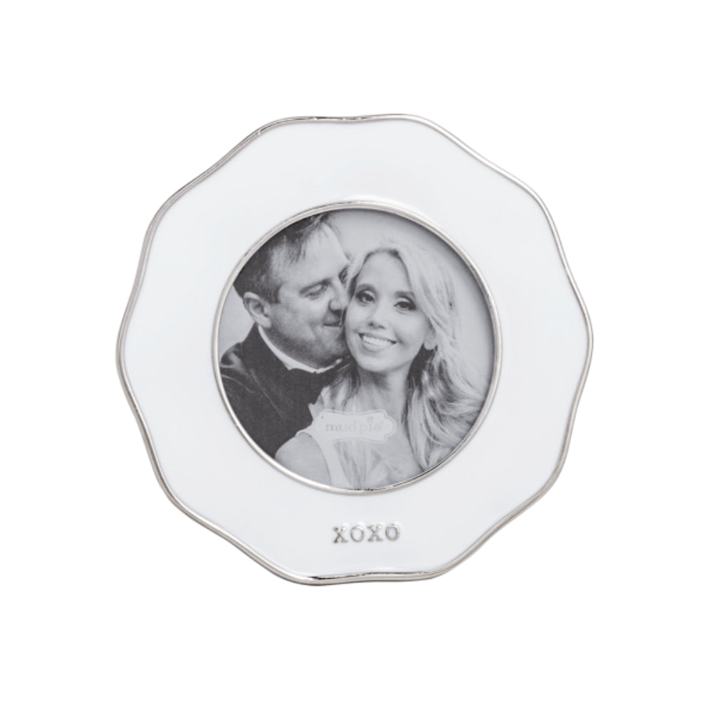 Decorative white photo frame with a couple's picture and 'XOXO' text on a white background.